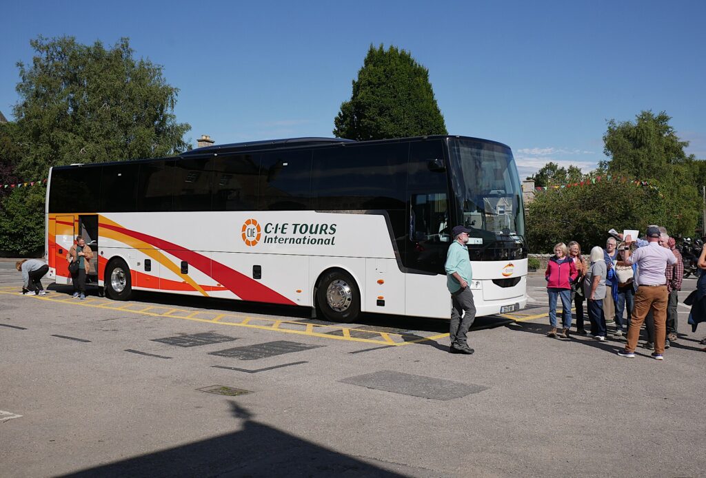 CIE Tours International coach with passengers boarding in sunny weather