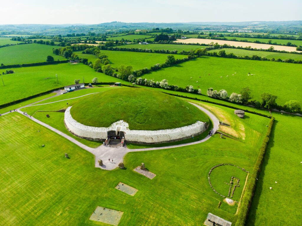 Aerial view of ancient circular stone monument in green Irish countryside