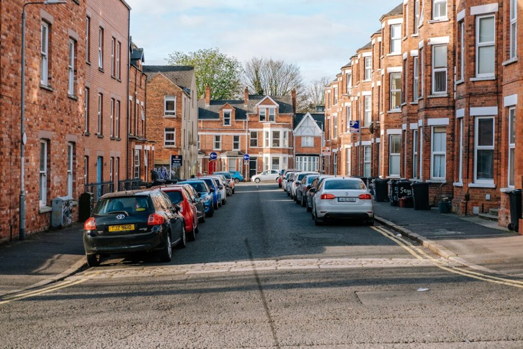 Cars line the street in a european town